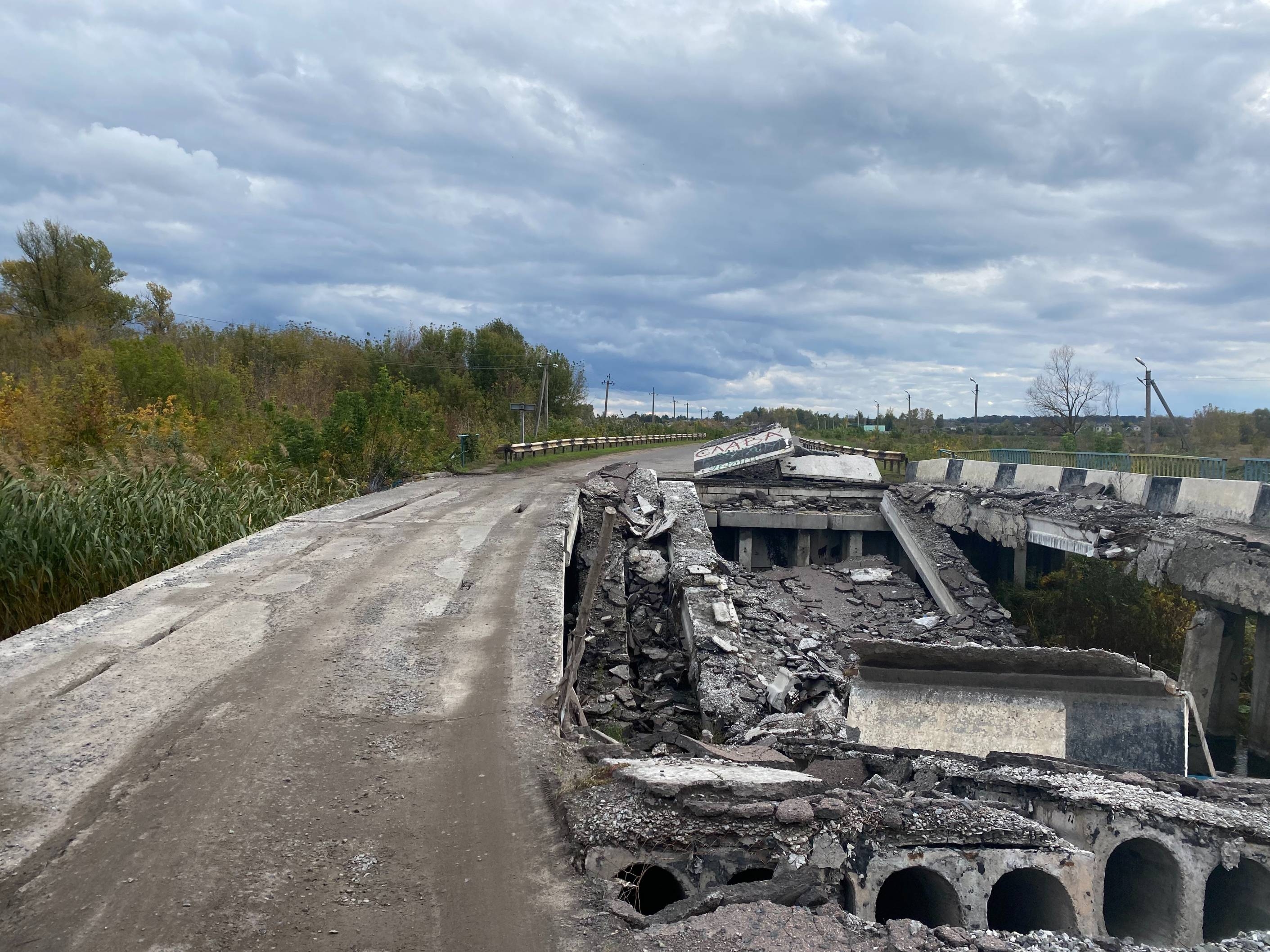 The bridge leading to the city has been blown in half during hostilities. Bringing goods into the city is a massive challenge for the locals. (Alexander Query)