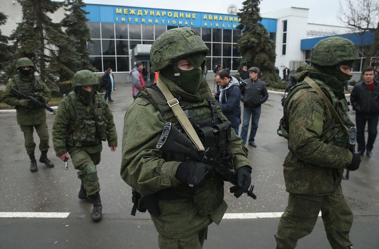 Russian soldiers, wearing no identifying insignia, patrol outside the Simferopol International Airport after a pro-Russian crowd had gathered near Simferopol, Crimea, Ukraine on Feb. 28, 2014