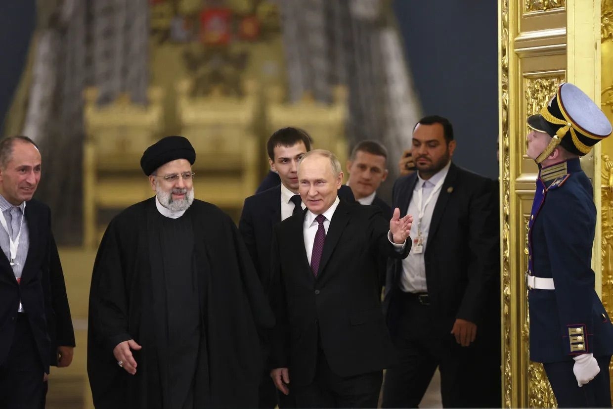 Russia's President Vladimir Putin and Iran's President Ebrahim Raisi walk together following their meeting in the Kremlin in Moscow Dec. 7, 2023. 