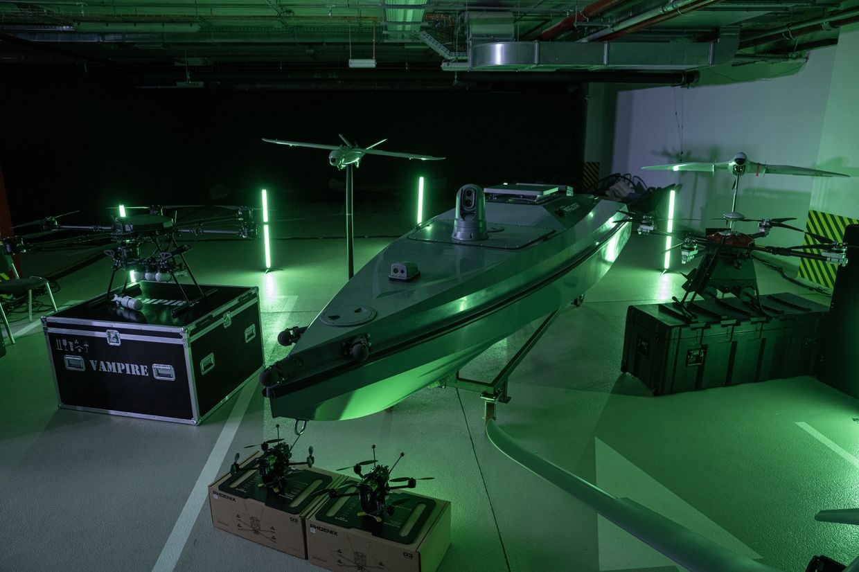 A "Magura"surface combat drone, center, beside aerial drones during a presentation of drone military hardware of the Unmanned Systems Force of the Ukraine Armed Forces in Kyiv, Ukraine, on June 11, 2024.