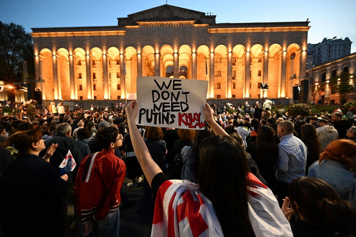 Protestors gather outside the parliament during a demonstration against a draft bill on "foreign influence" in Tbilisi on April 16, 2024. 