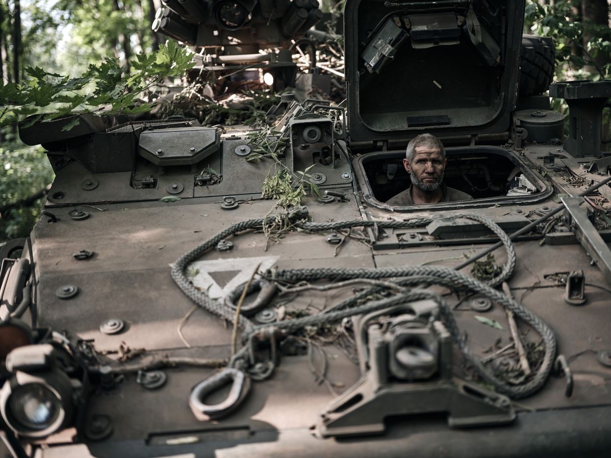 A Ukrainian mechanic who is driving an American Stryker armored vehicle after returning from a combat mission in the Kursk Region