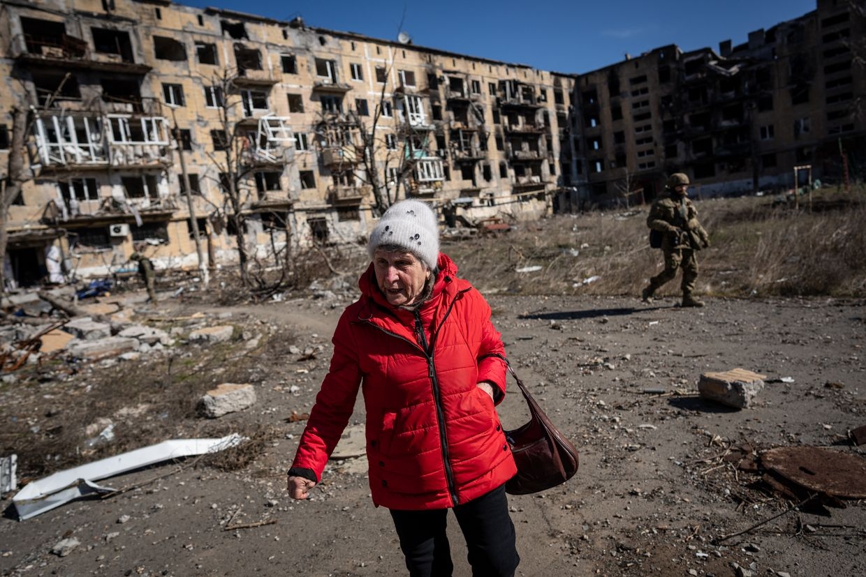 An old woman is seen in front of a damaged building in the frontline city of Vuhledar as the Russia-Ukraine war continues in Donetsk 