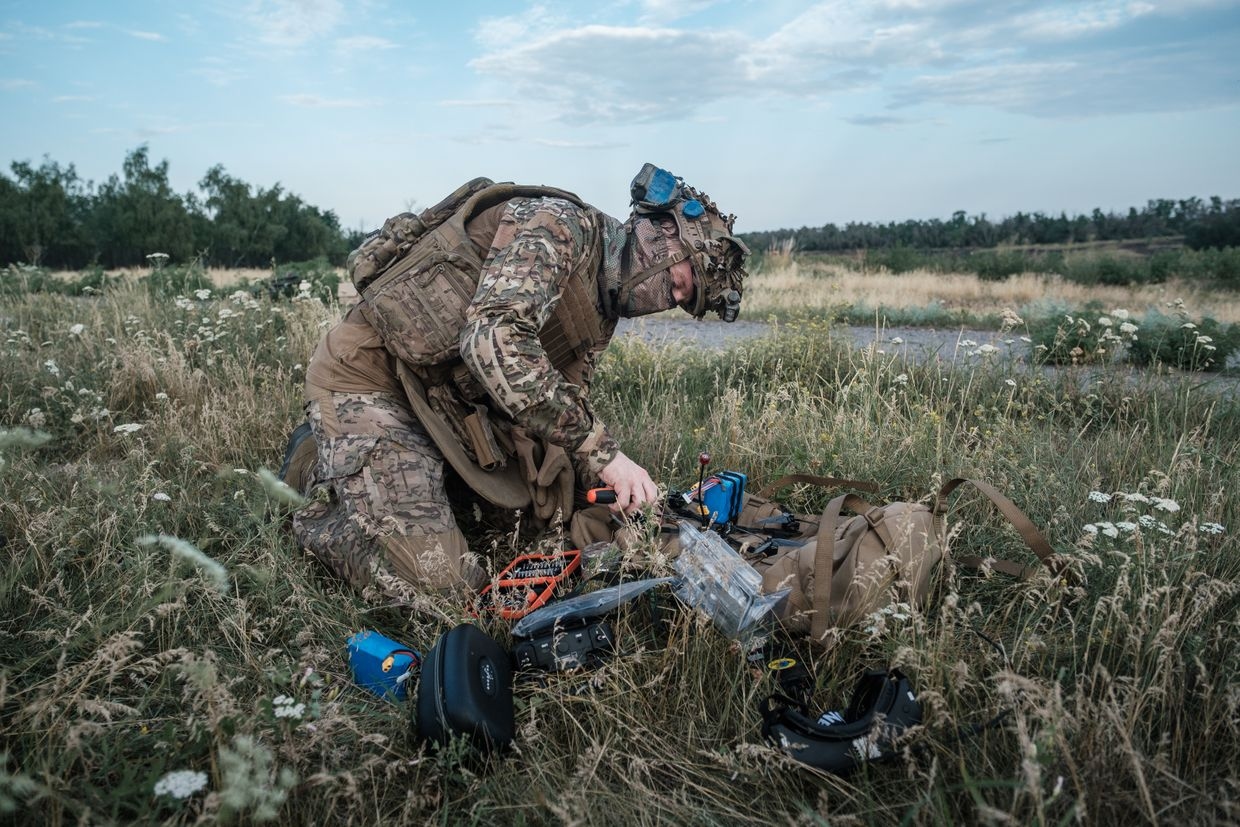 Sniper of the 1st brigade of National Guard "Bureviy" uses a drone to check his teammate's shot during training 