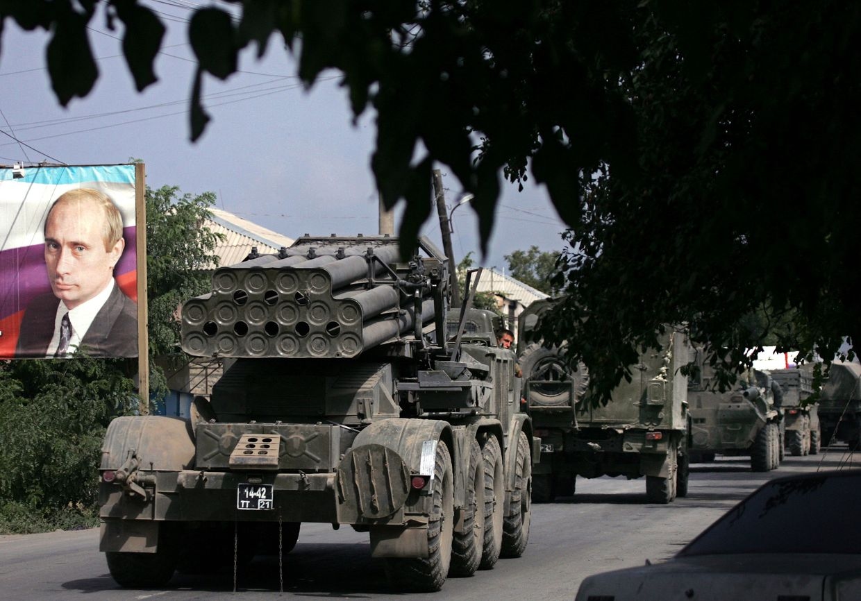 Russian multiple rocket launchers "Uragan" pass a banner featuring a portrait of then-Russian Prime Minister Vladimir Putin in Tskhinvali, Georgia, on Aug. 25, 2008.