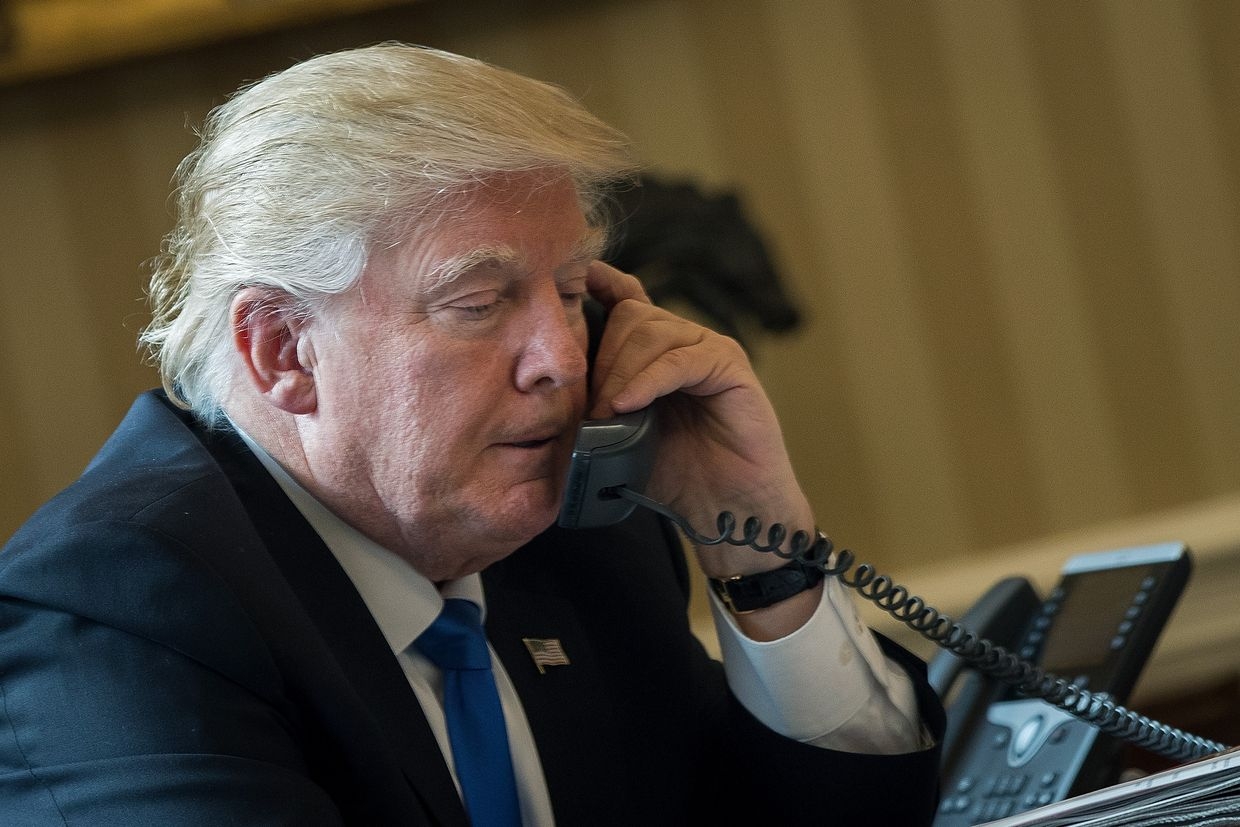 President Donald Trump speaks on the phone with Russian President Vladimir Putin in the Oval Office of the White House. US