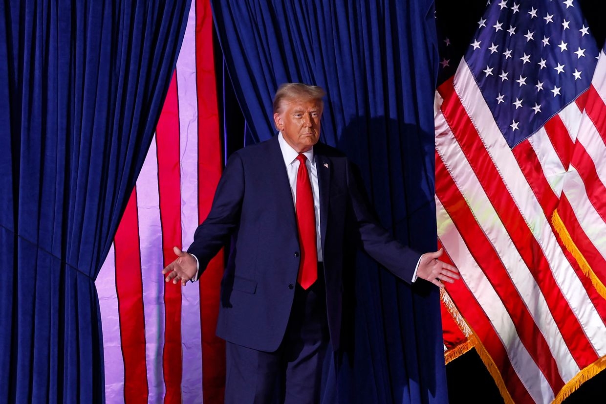 Former US President Donald Trump walks on stage during a campaign rally at Van Andel Arena in Grand Rapids, Michigan, on Nov. 5, 2024.