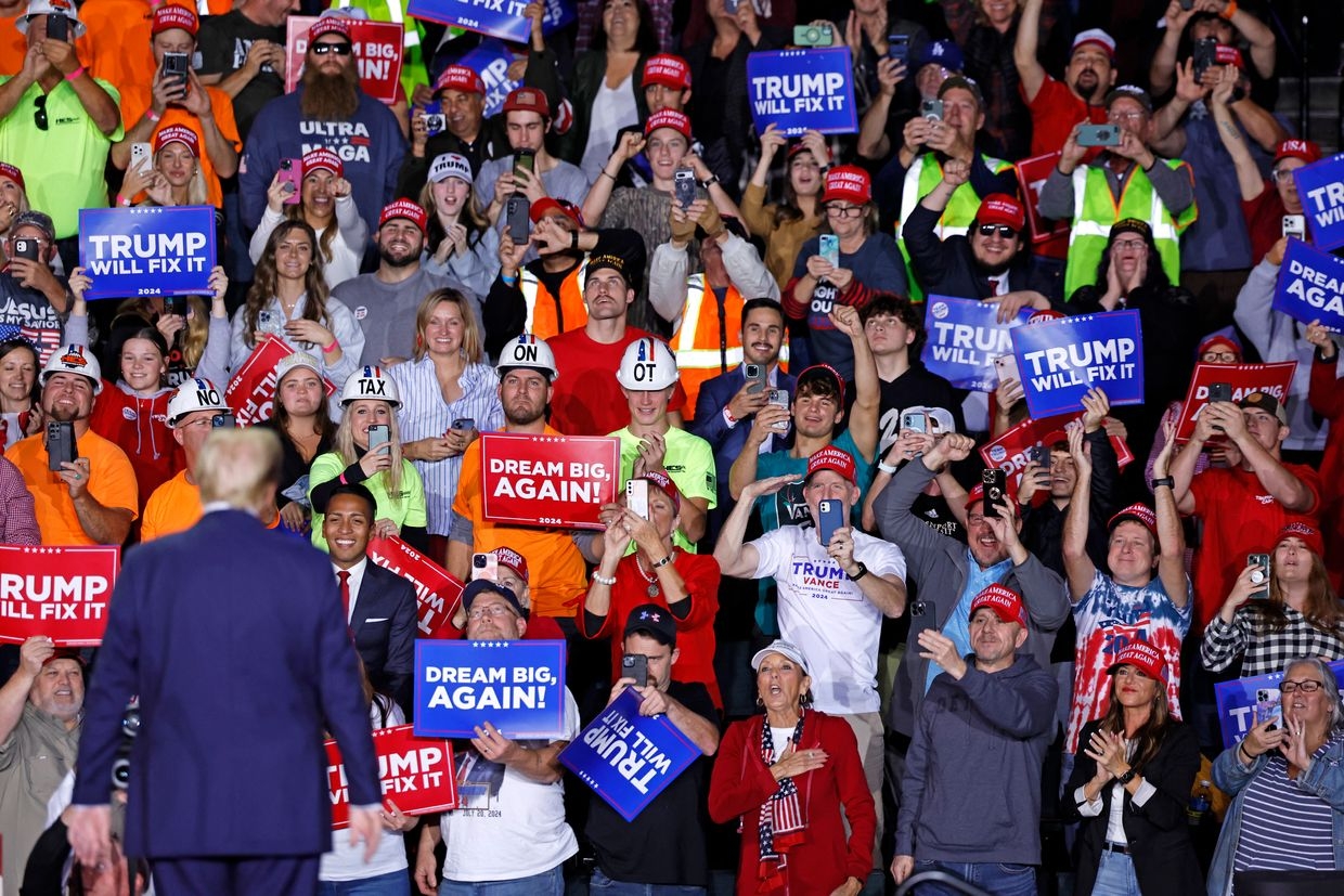 Former US President Donald Trump looks at supporters as he walks on stage during a rally at Van Andel Arena in Grand Rapids on Nov. 5, 2024.