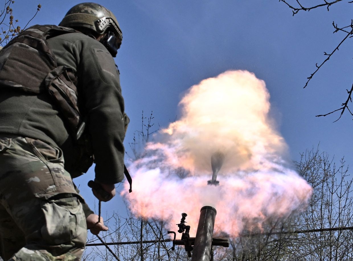  A Belarusian volunteer from the Kastus Kalinouski Regiment fires a 120mm mortar near Bakhmut, Donetsk Oblast, Ukraine, on Apr. 9, 2023.