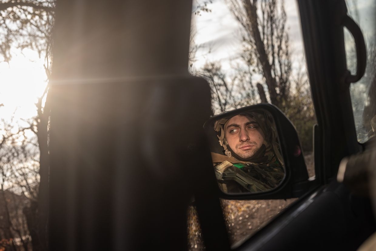  A Ukrainian soldier is reflected in a car mirror en route to a fighting position near Toretsk, Donetsk Oblast, Ukraine, on Nov. 17, 2024.