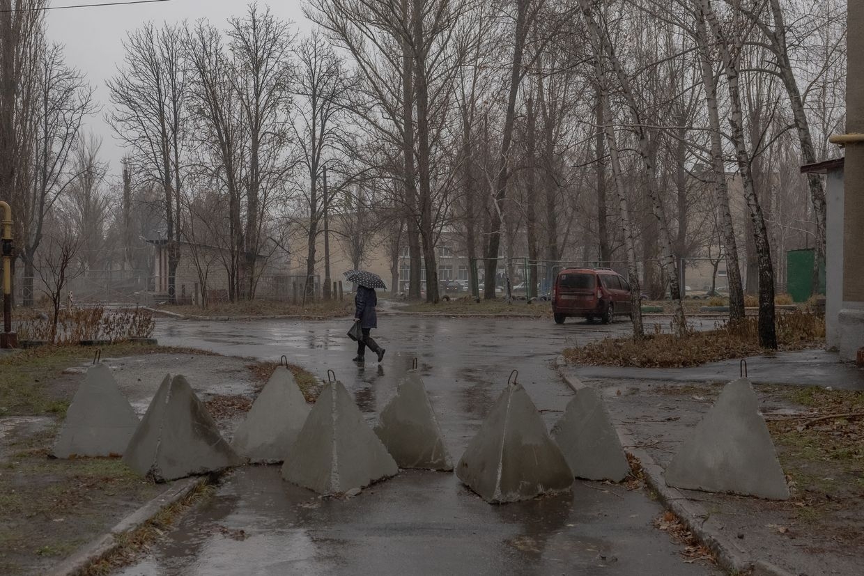  A local resident walks past "dragon's teeth" fortifications by the Ukrainian army in Pokrovsk, Donetsk Oblast, Dec. 11, 2024.