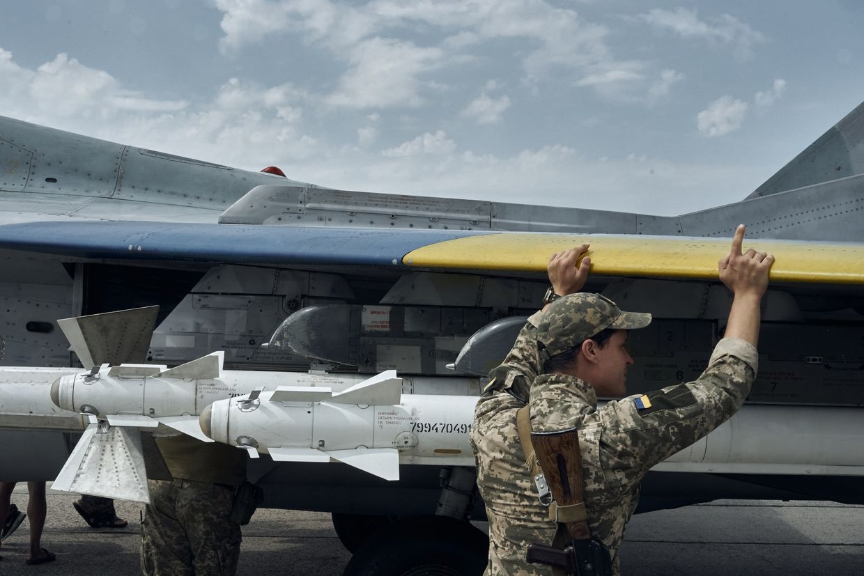 Maintenance staff perform routine upkeep of MiG-29 aircraft after the flight in eastern Ukraine on Aug. 2, 2023. 