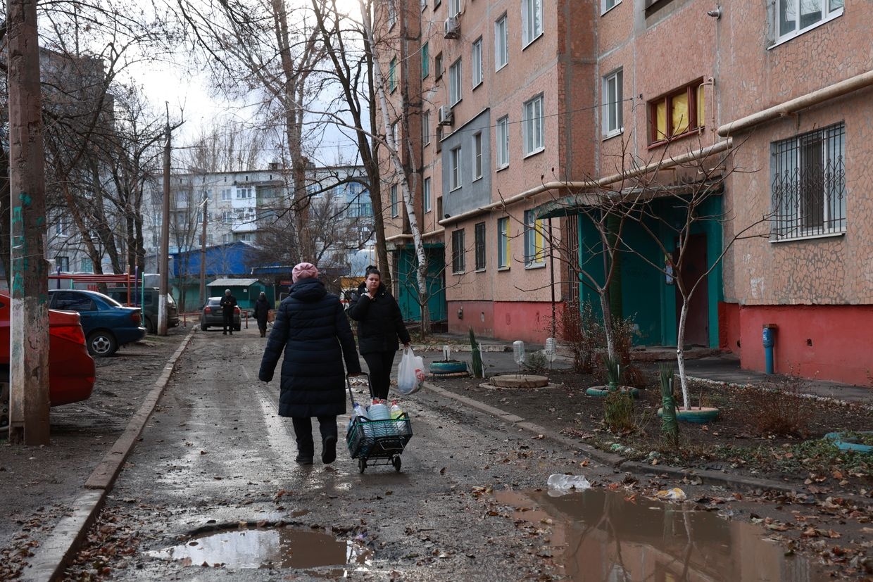 A local resident goes to the water pump room to get some water in Druzhkivka, Ukraine on Dec. 18, 2024.