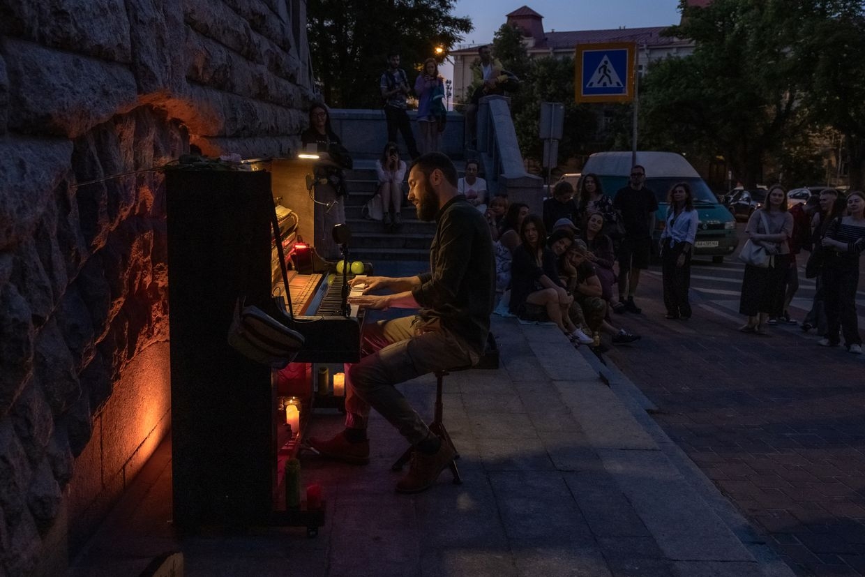A street musician plays the piano during a blackout in Kyiv, Ukraine, on June 6, 2024, after Russian strikes on energy infrastructure.