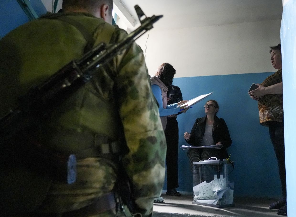 Residents cast their votes in a sham 'referendum' in Donetsk Oblast, Ukraine, on Sept. 23, 2022.