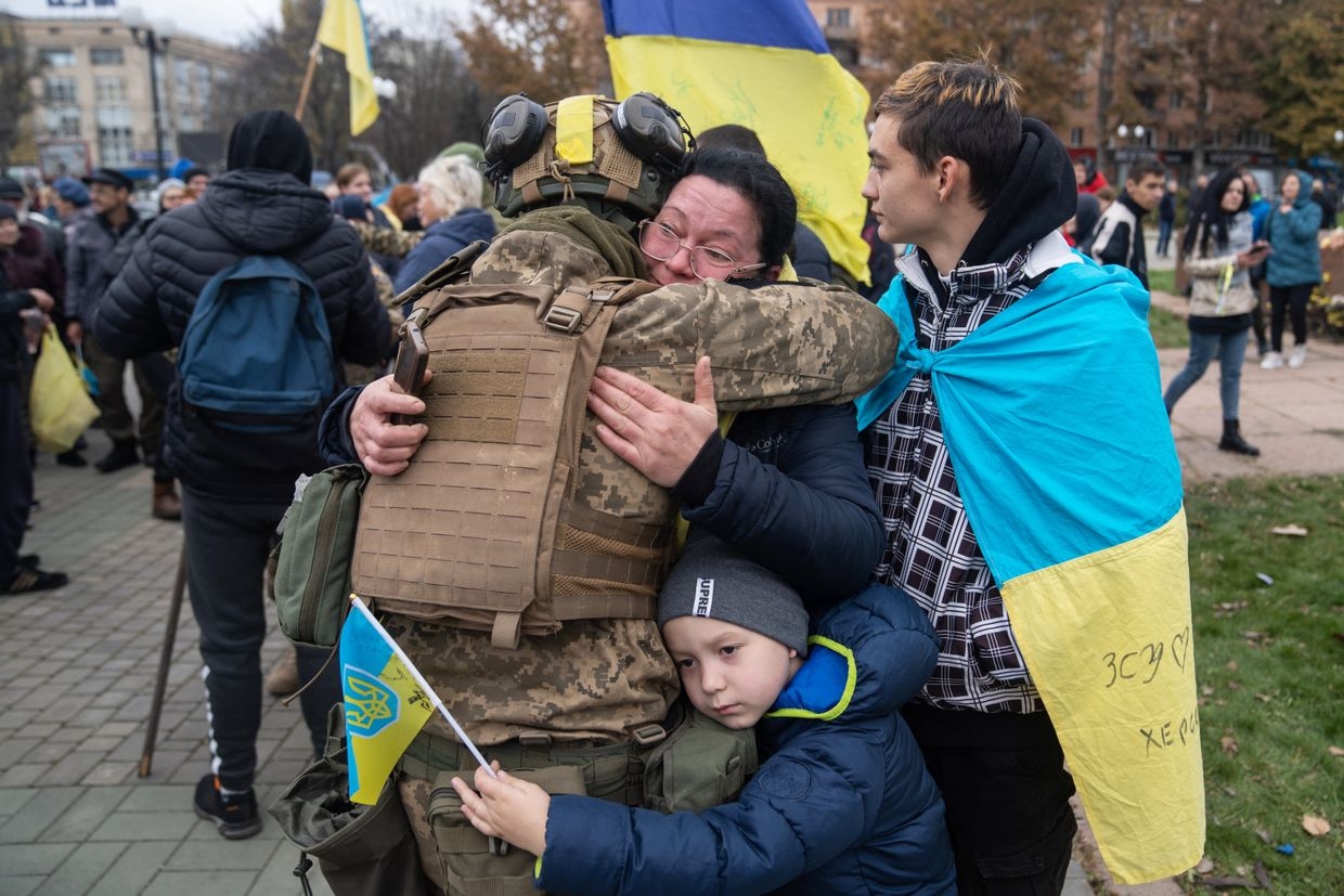 Local residents hug a Ukrainian soldier as they celebrate the liberation of Kherson, Ukraine, on Nov. 13, 2022. 