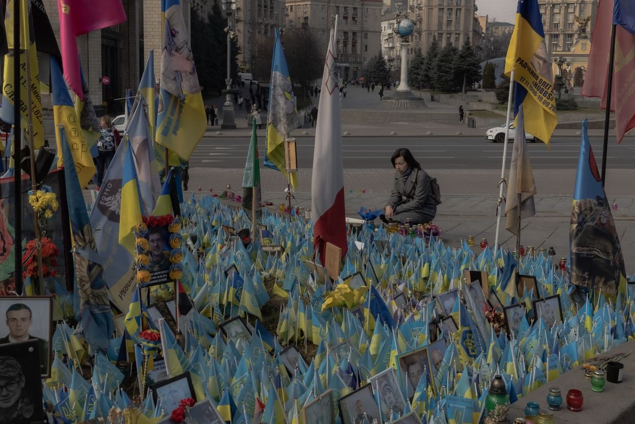 A woman visits a makeshift memorial for fallen Ukrainian and foreign fighters on Independence Square in Kyiv, Ukraine, on March 11, 2025. 