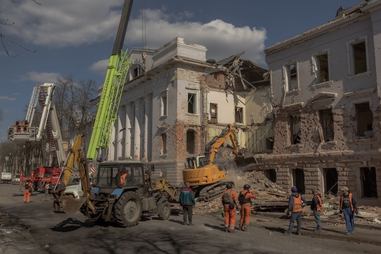 Ukrainian emergency workers search through the rubble at the site of a Russian missile attack in Sumy, Ukraine, on April 14, 2025.