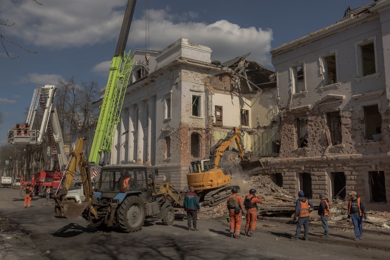 Ukrainian emergency workers search through the rubble at the site of a Russian missile attack in Sumy, Ukraine, on April 14, 2025.