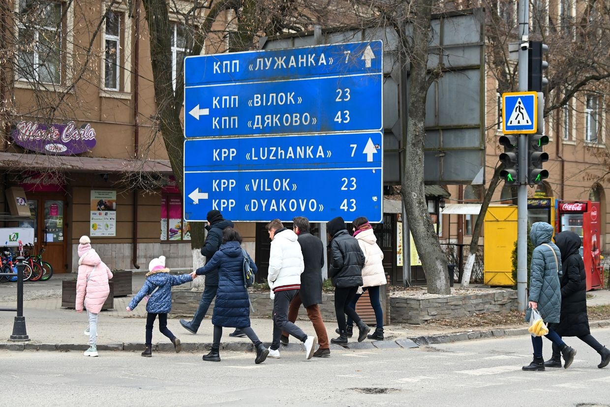 Local residents walk along a street in Berehove, Ukraine, on March 7, 2022. 