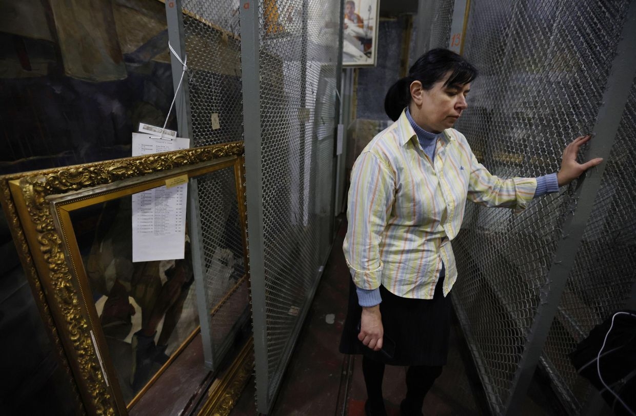 A museum staffer stands in an empty storage room at an art museum in Kherson, Ukraine, on Dec. 8, 2022.