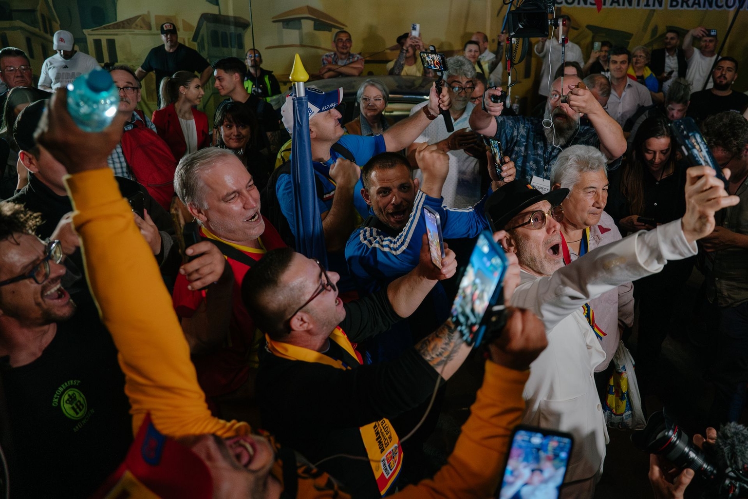 Supporters of presidential candidate George Simion celebrate after exit poll results outside his campaign headquarters in Bucharest, Romania, on May 4, 2025. 