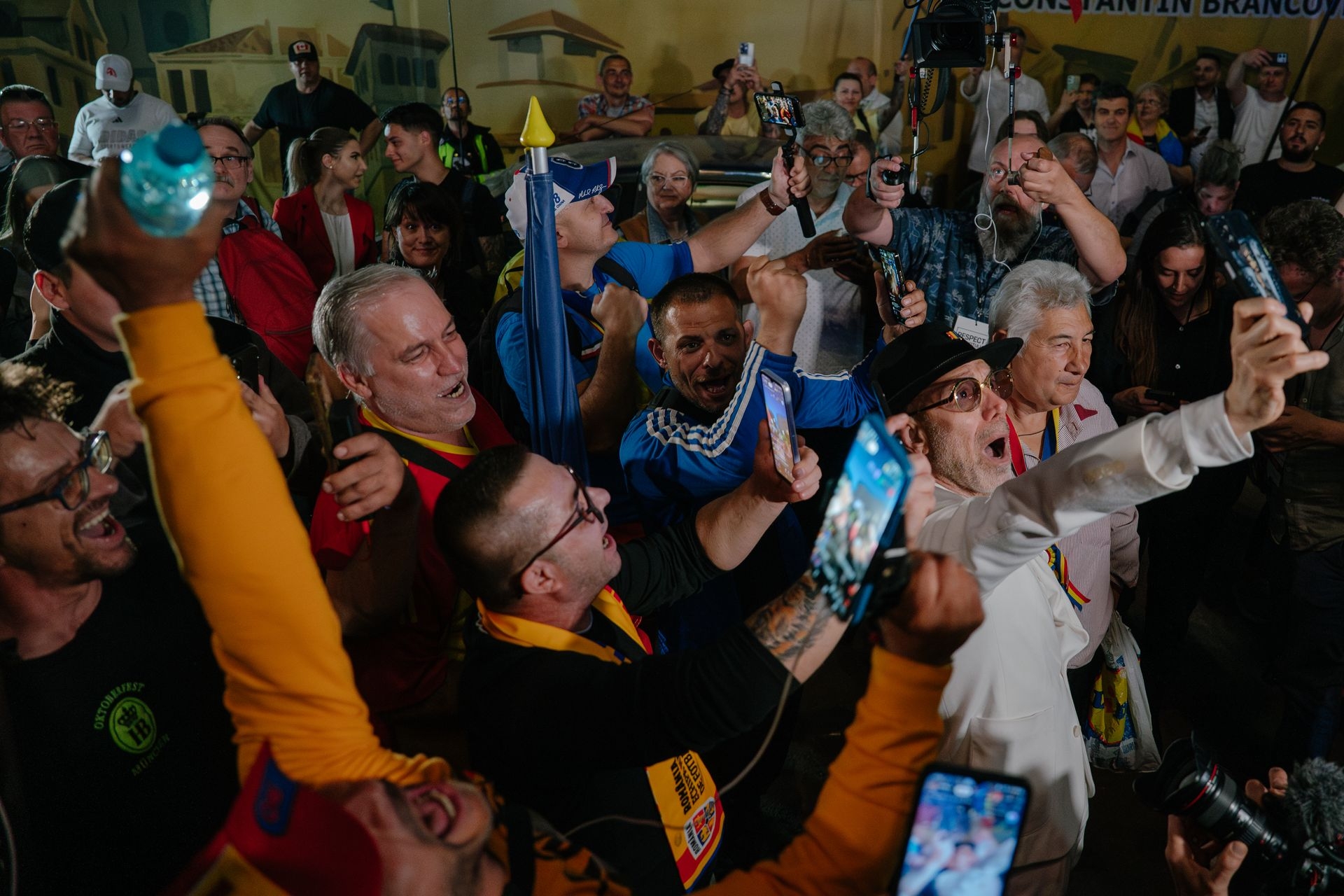 Supporters of presidential candidate George Simion celebrate after exit poll results outside his campaign headquarters in Bucharest, Romania, on May 4, 2025. 