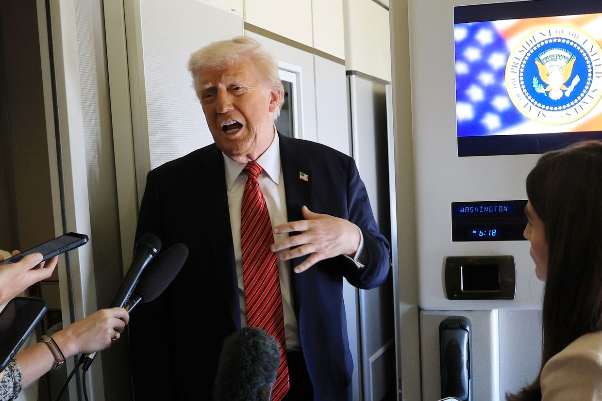 U.S. President Donald Trump speaks to traveling media aboard Air Force One en route to Doha, Qatar, on May 14, 2025. 
