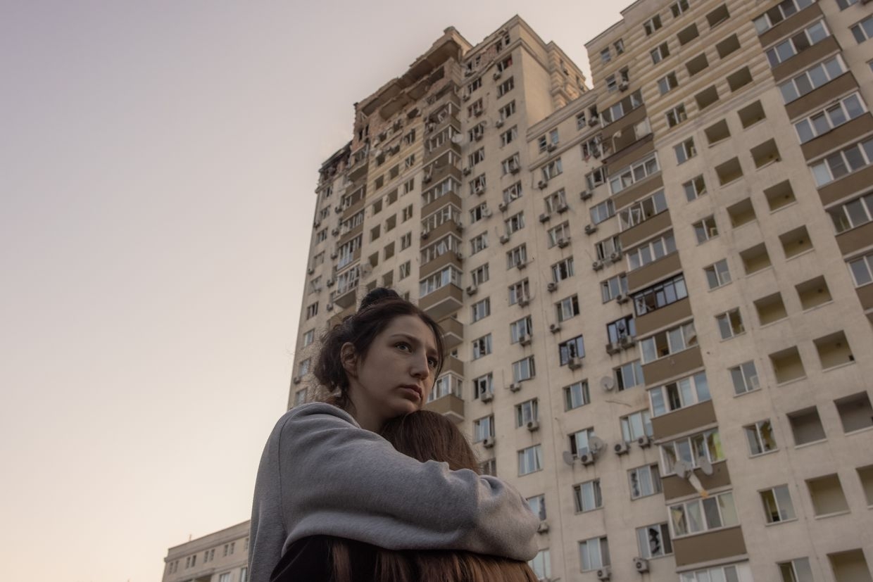Women embrace outside a residential building damaged by a Russian drone attack in Kyiv, Ukraine, on May 30, 2023. 