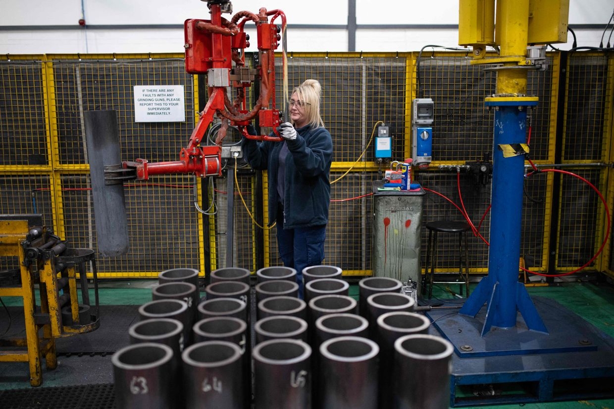 An employee maneuvers 155mm artillery shell casings during manufacturing at the BAE Systems factory in Washington, United Kingdom, on Nov. 8, 2023.