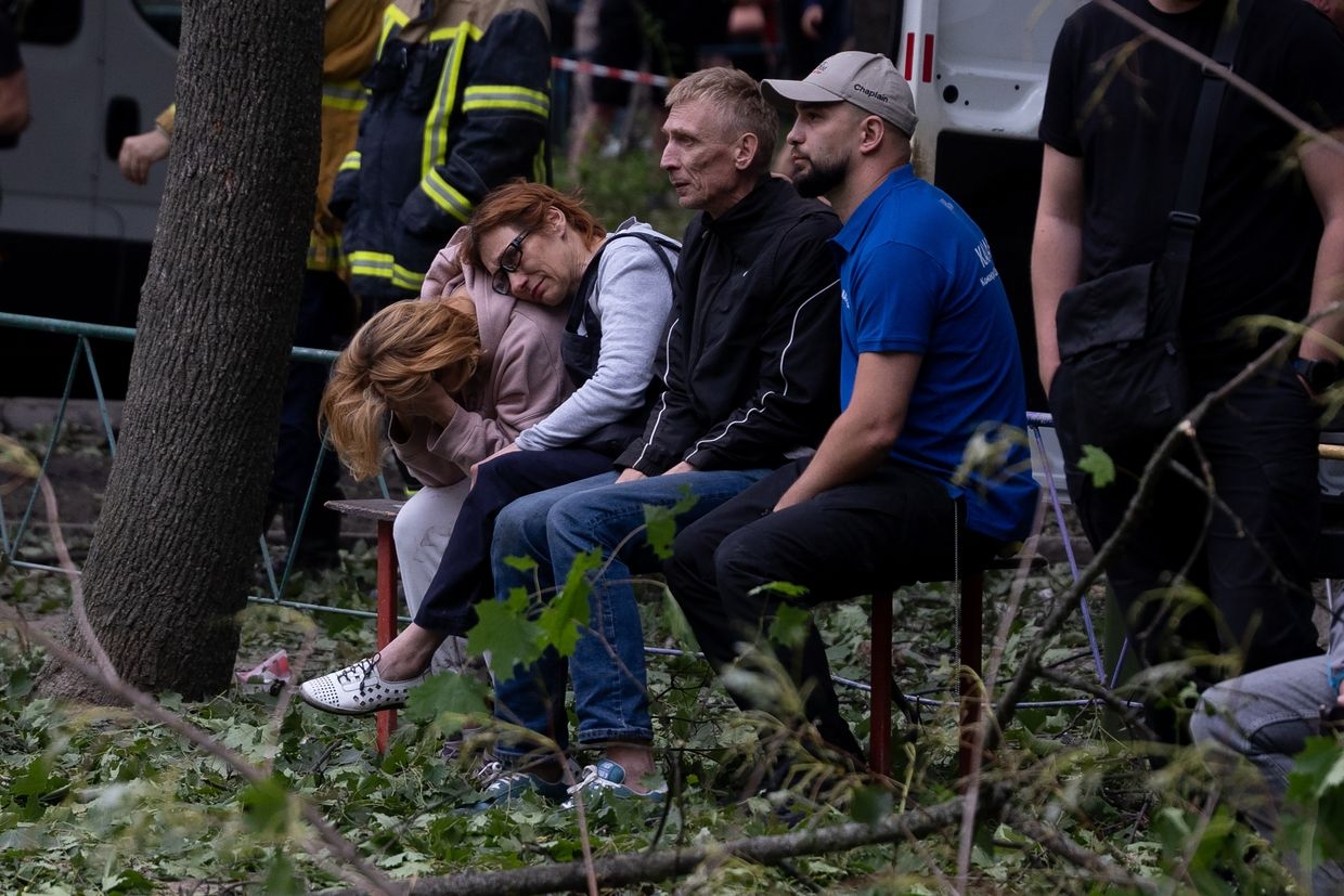 Parents wait as rescuers search for their missing son in the rubble of a collapsed building after a Russian attack in Kyiv, Ukraine, on June 17, 2025.