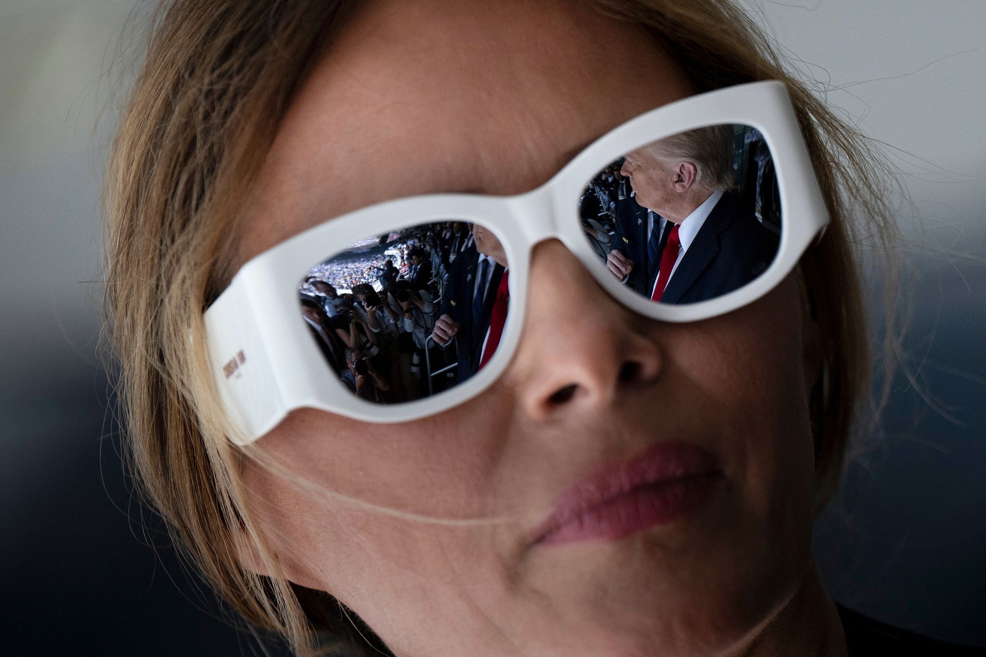 U.S. President Donald Trump is reflected in First Lady Melania Trump’s sunglasses in East Rutherford, New Jersey, U.S., on July 13, 2025.