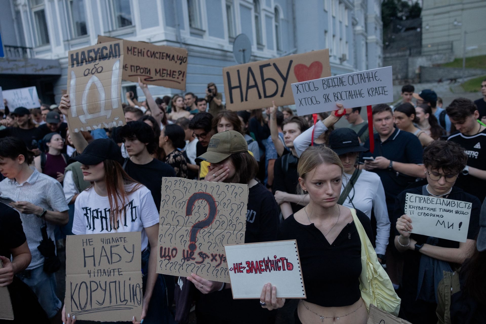 Protesters hold placards during a demonstration in downtown Kyiv, Ukraine, on July 22, 2025