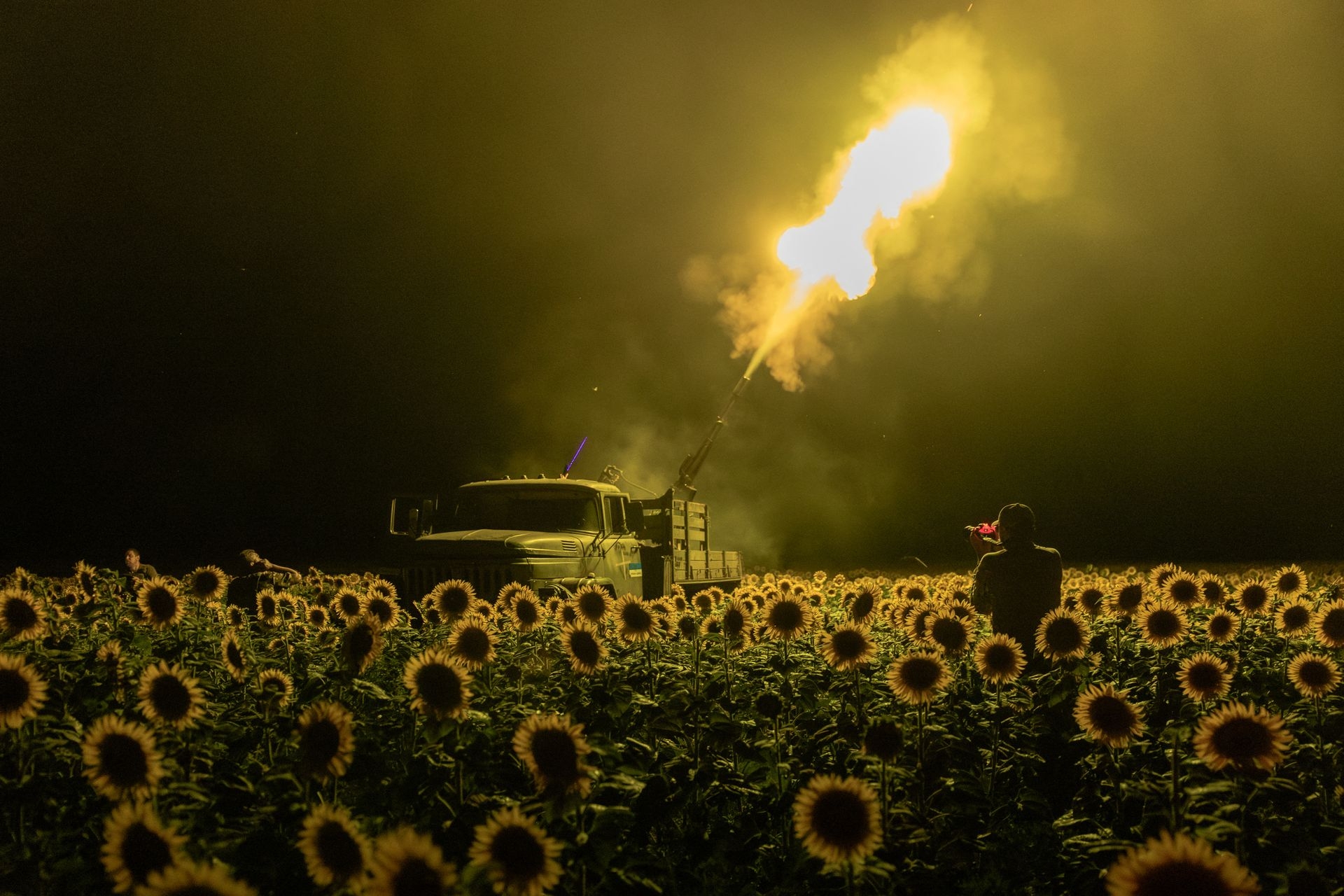 Ukrainian servicemen of the 59th Brigade mobile air defence unit fire a Soviet-made ZU-23 anti-aircraft twin autocannon toward a Russian drone from a sunflower field during an air attack near Pavlohrad, Dnipropetrovsk Oblast, Ukraine, on July 19, 2025.