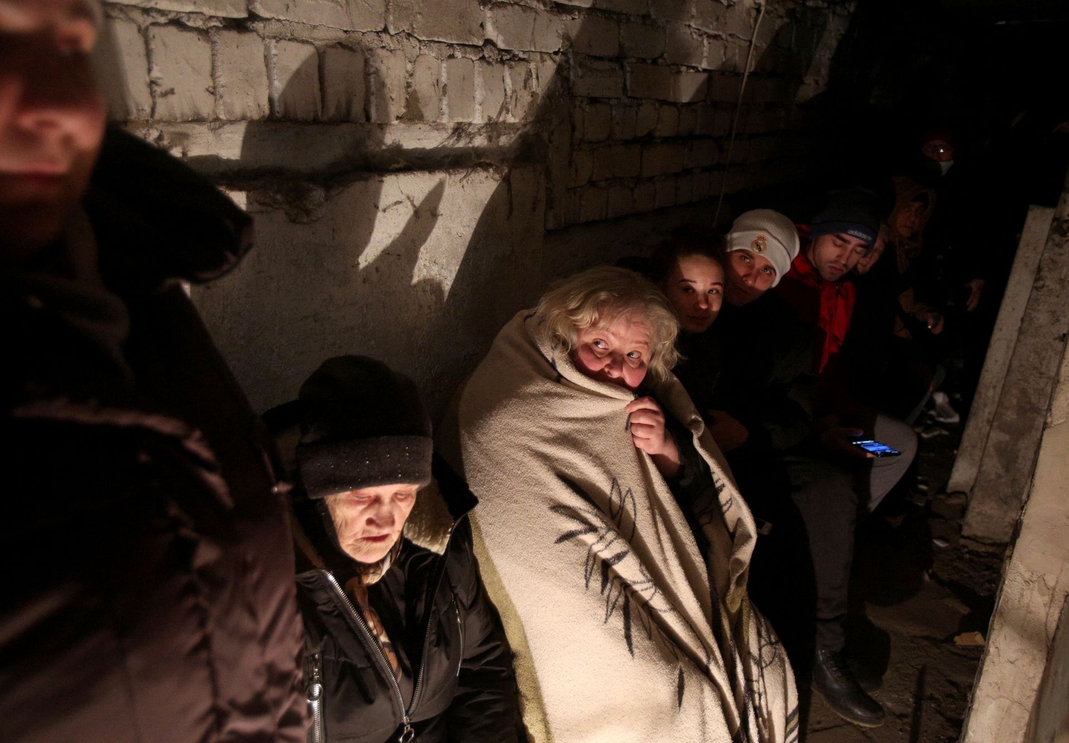 People take shelter in a basement during heavy shelling by Russian forces in Sievierodonetsk, Luhansk Oblast, Ukraine, on Feb. 28, 2022.