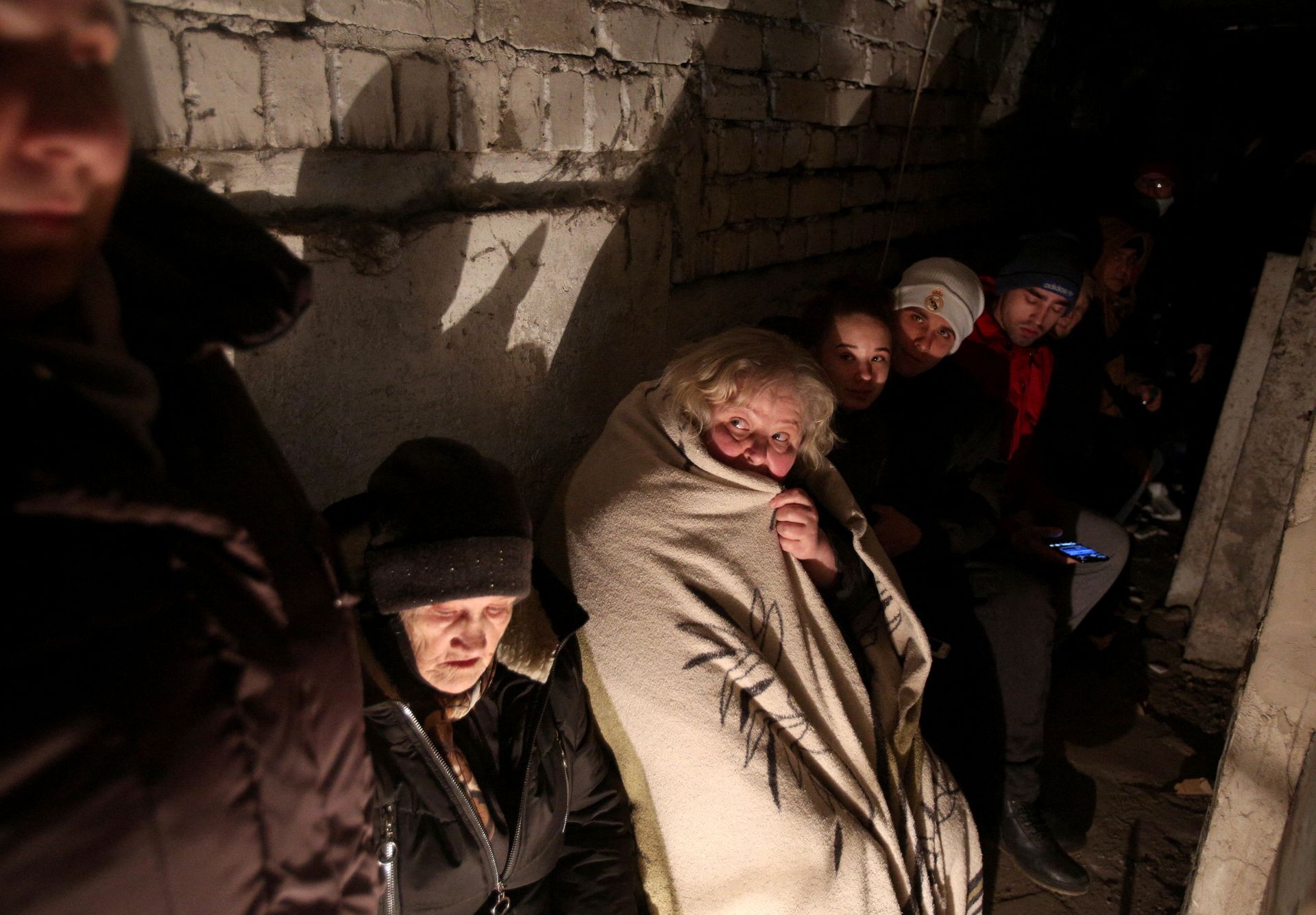 People take shelter in a basement during heavy shelling by Russian forces in Sievierodonetsk, Luhansk Oblast, Ukraine, on Feb. 28, 2022.