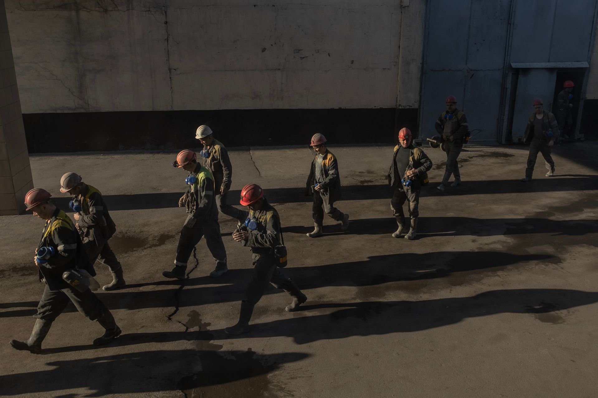 Miners walk out after finishing their shift at a coal mine in the western part of Donbas, Ukraine, on Oct. 11, 2024.