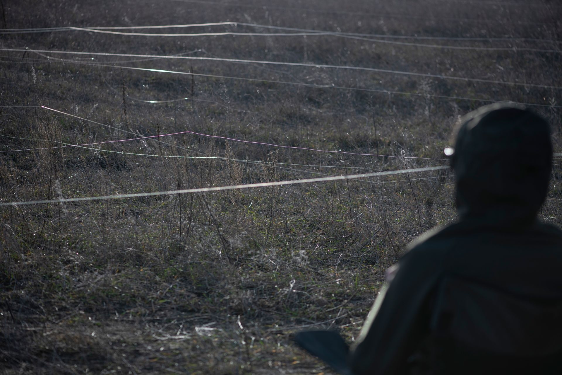 A person wearing a VR headset operates a drone controlled via a fiber-optic cable during a test flight in Kyiv Oblast, Ukraine, on Dec. 26, 2024.