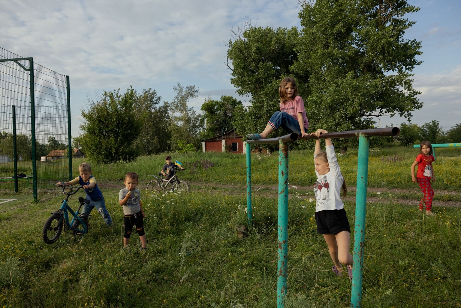 Children play near a public soccer field in a village in Dnipropetrovsk Oblast, Ukraine, on June 25, 2025.