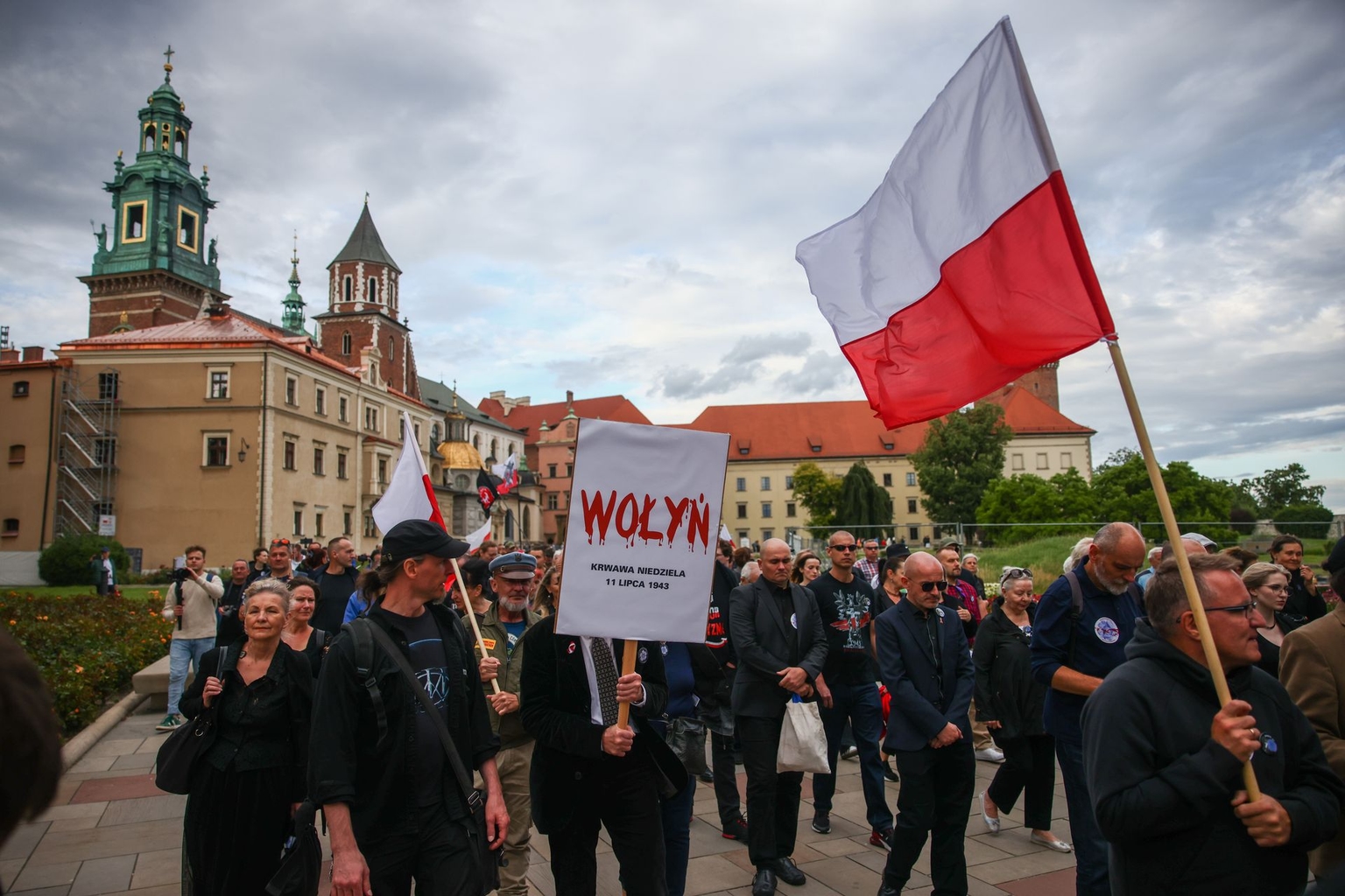 Participants hold banners and Polish flags during a march in Kraków, Poland, commemorating the victims of the Volyn tragedy on July 11, 2024.