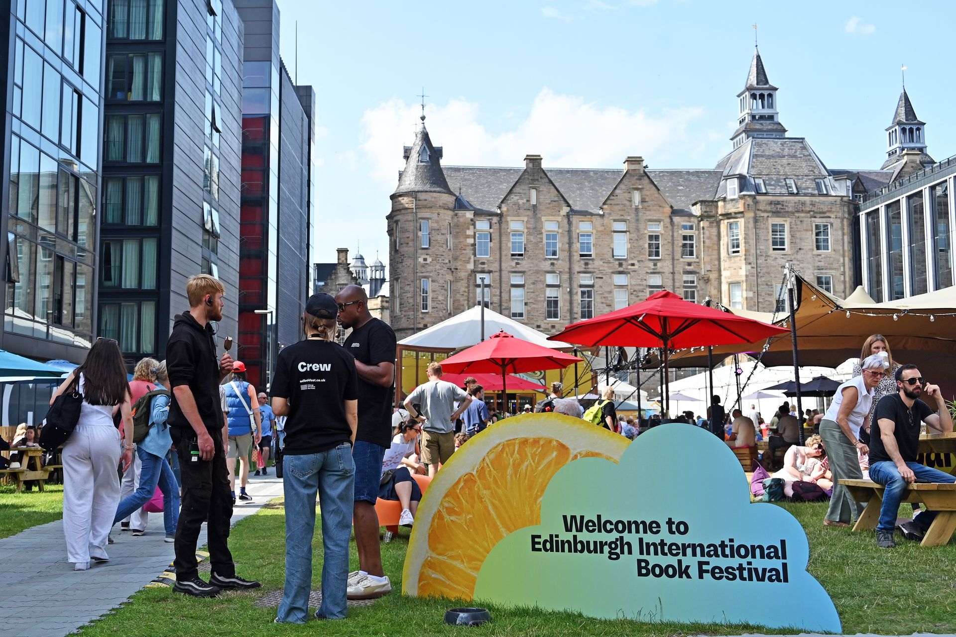 People sit in the gardens during the Edinburgh International Book Festival in Edinburgh, Scotland, on Aug. 12, 2025.
