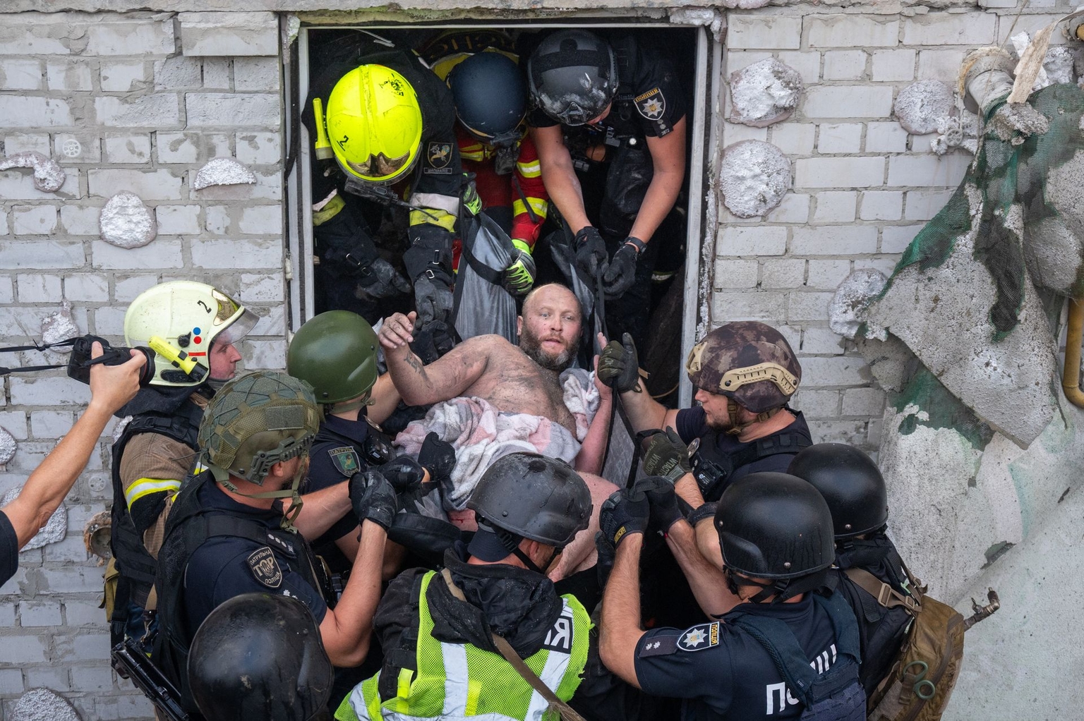 Rescuers carry an injured civilian from a building damaged by Russian drone strikes in Kharkiv, Ukraine, on Aug. 18, 2025. 