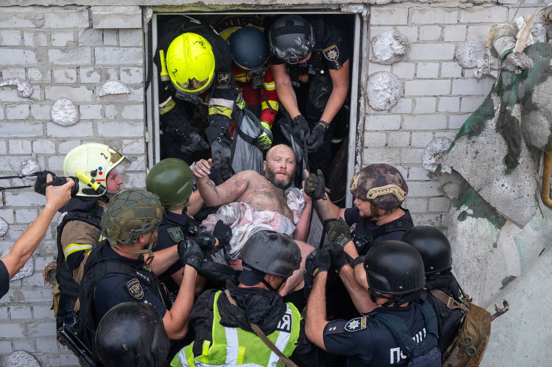Rescuers carry an injured civilian from a building damaged by Russian drone strikes in Kharkiv, Ukraine, on Aug. 18, 2025. 