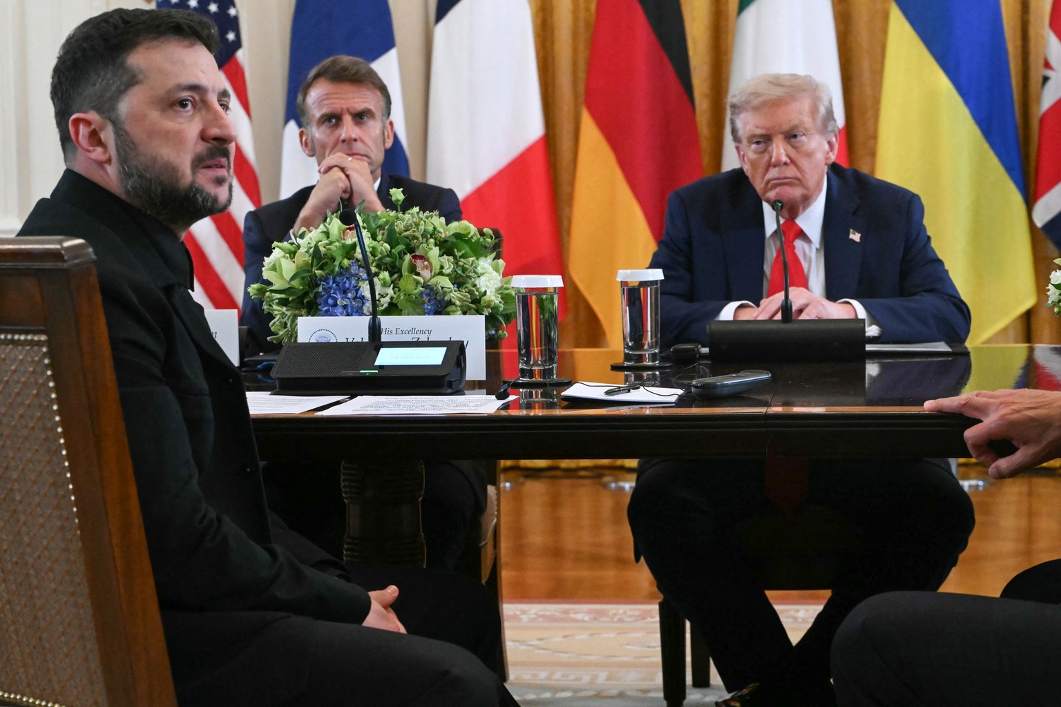 French President Emmanuel Macron (C) and U.S. President Donald Trump (R) listen as President Volodymyr Zelensky (L) speaks during a meeting with European leaders in Washington, D.C., U.S. on Aug. 18, 2025. 