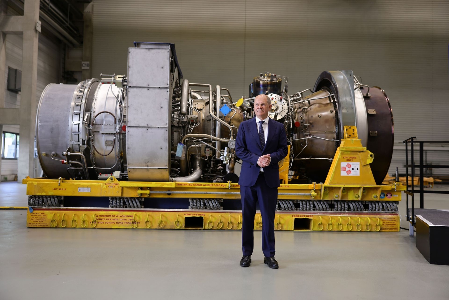 German Chancellor Olaf Scholz poses in front of a Siemens gas turbine intended for the Nord Stream 1 pipeline at a Siemens Energy facility in Mülheim an der Ruhr, Germany, on Aug. 3, 2022. 