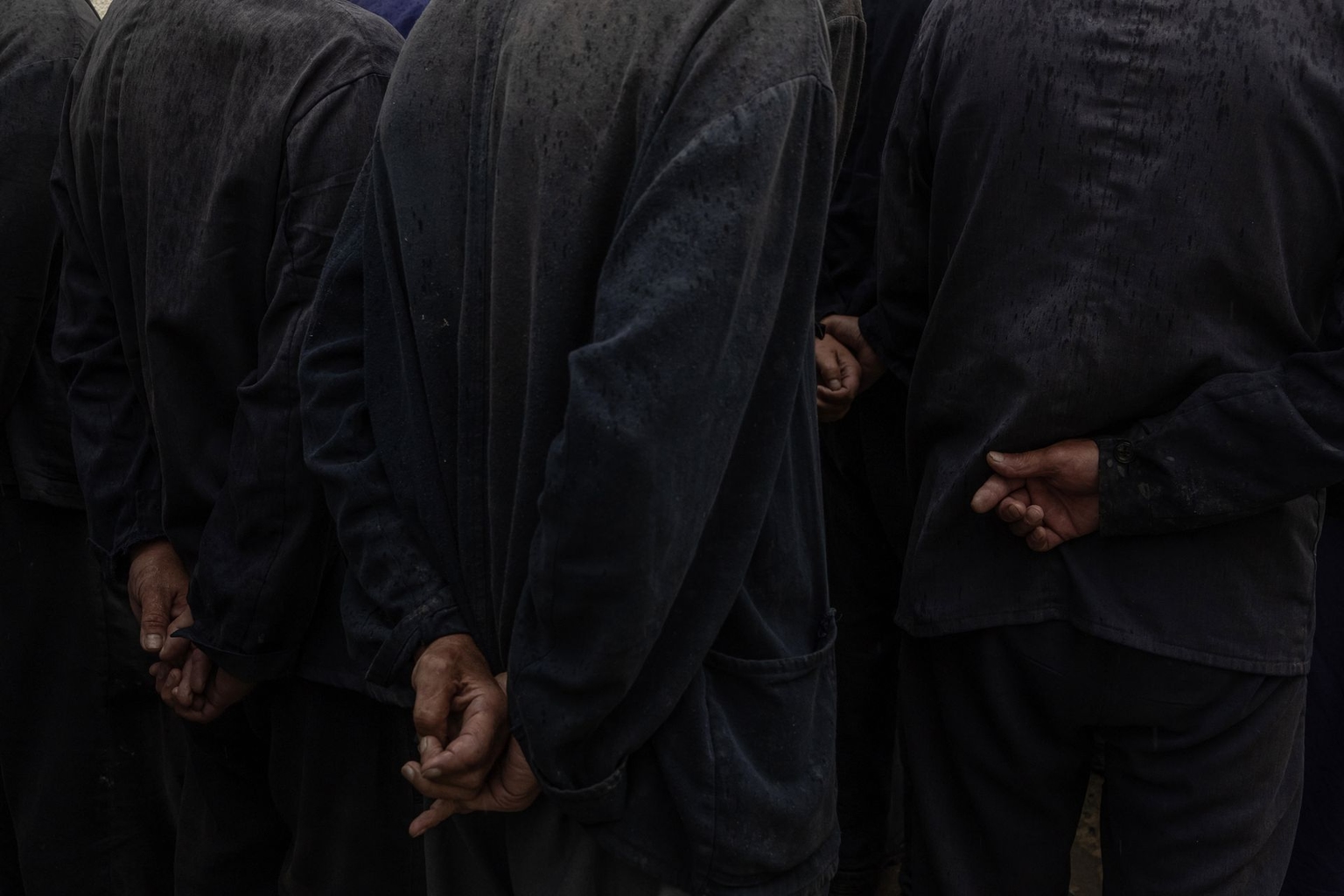 Russian POWs are seen living in a prisoner of war detention camp lining up for a meal 