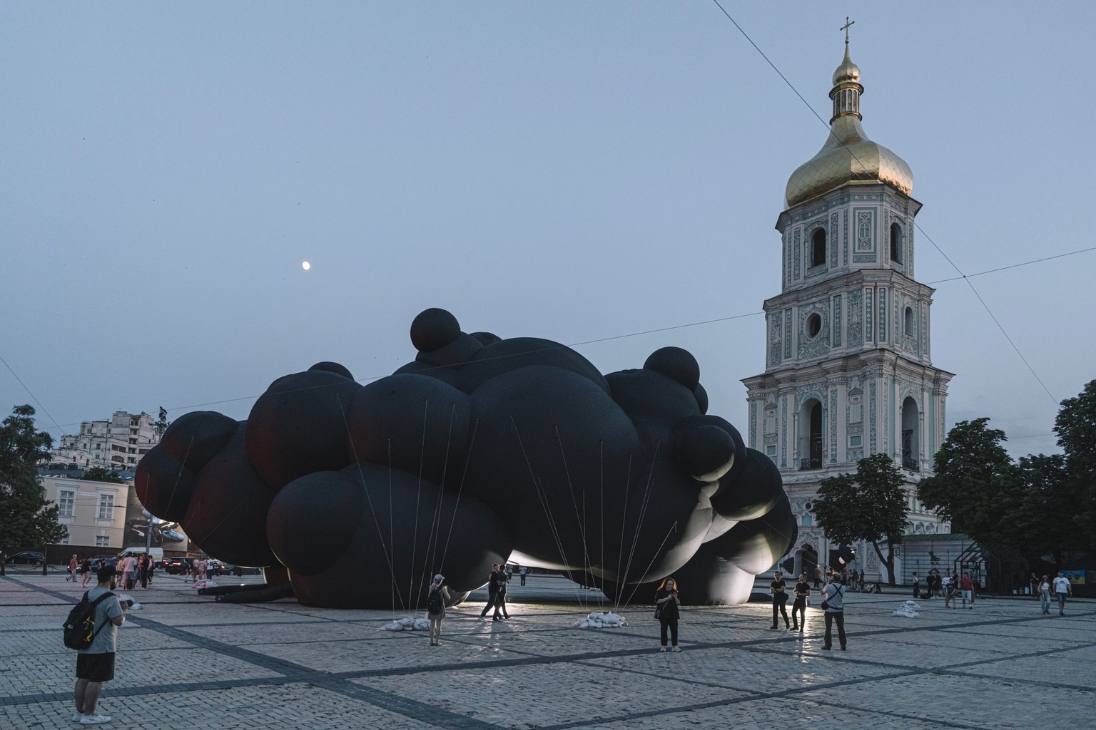 People view and photograph the “Black Cloud” installation at Sophia Square in Kyiv, Ukraine, on June 7, 2025. 