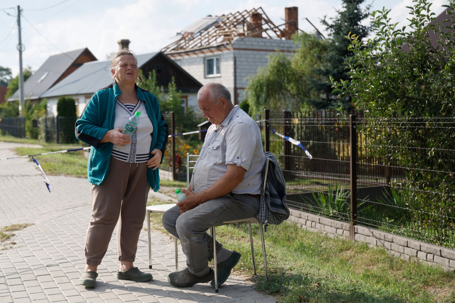 Alicja Wesolowska (L) and her husband Tomasz Wesolowski (R) in front of their damaged house, destroyed by debris from a shot-down Russian drone, in the village of Wyryki-Wola, Poland, on Sept. 10, 2025. 