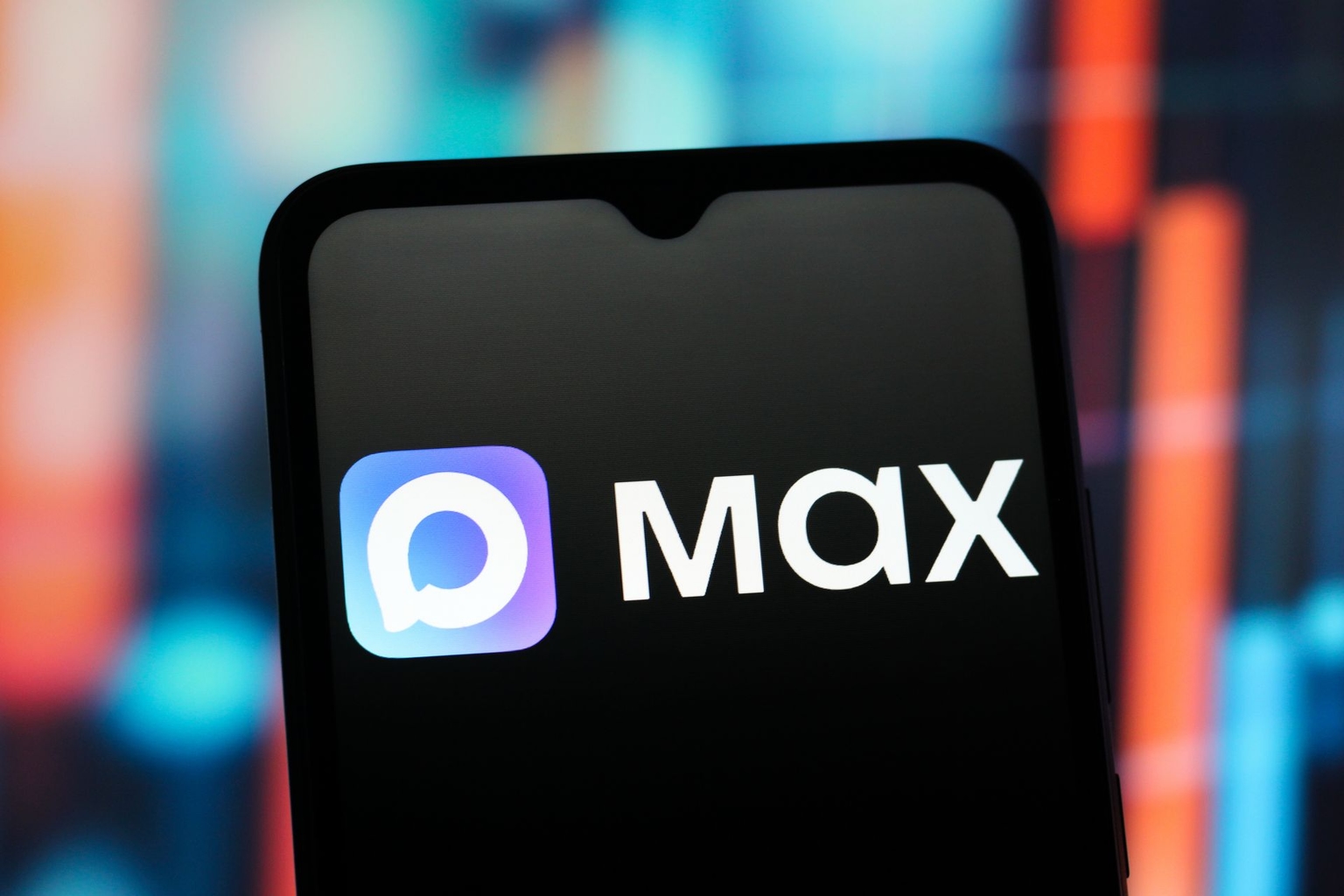 The Max Messenger logo is seen displayed on a smartphone screen. 