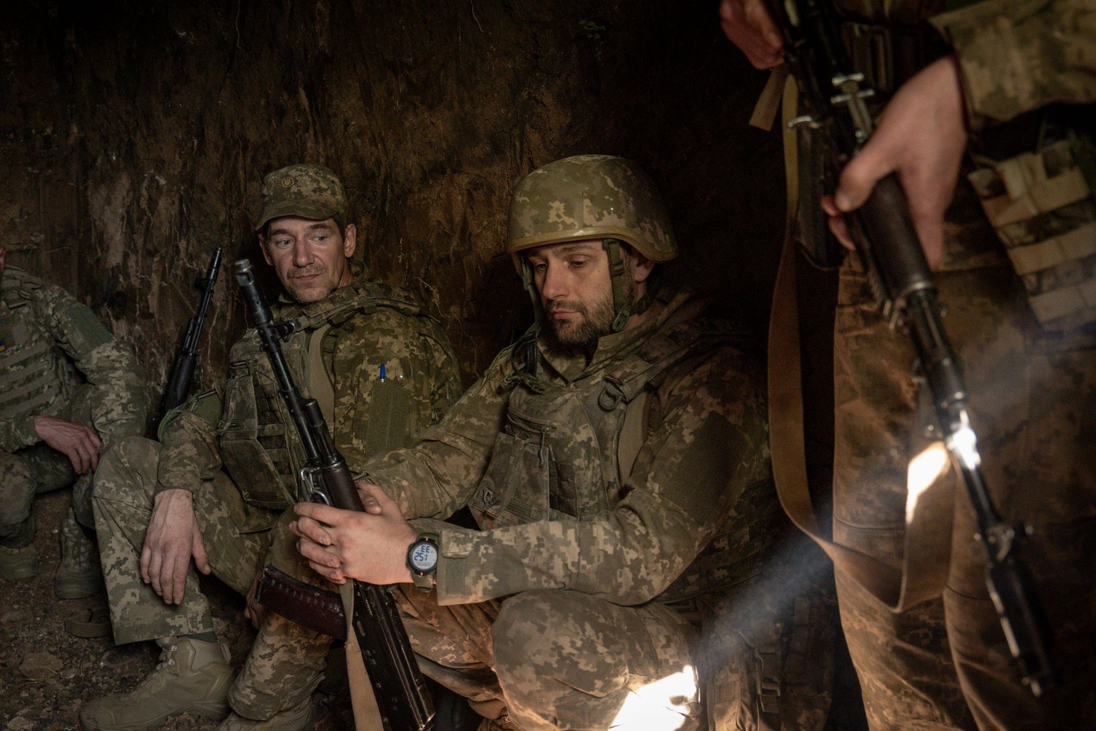 Soldiers of the 66th Separate Mechanized Brigade take cover from an enemy drone in a trench in Donetsk Oblast, Ukraine, on Oct. 25, 2025.